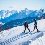 Skiing couple on the slope in Cortina d'Ampezzo