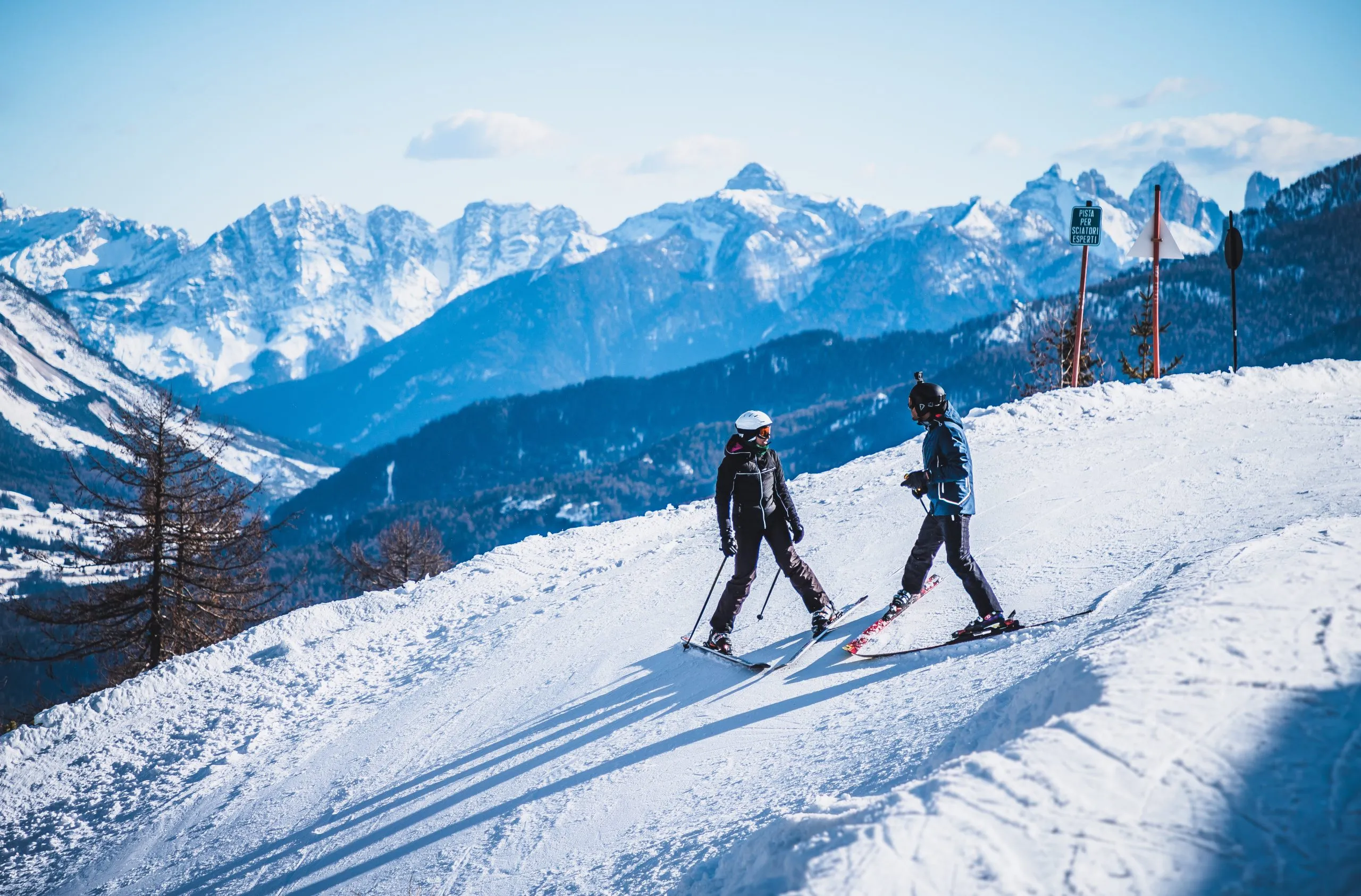 Skiing couple on the slope in Cortina d'Ampezzo