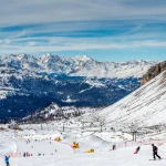 View on a sunlit ski slope and a Gondola ski lift in the Ski Resort Madonna di Campiglio