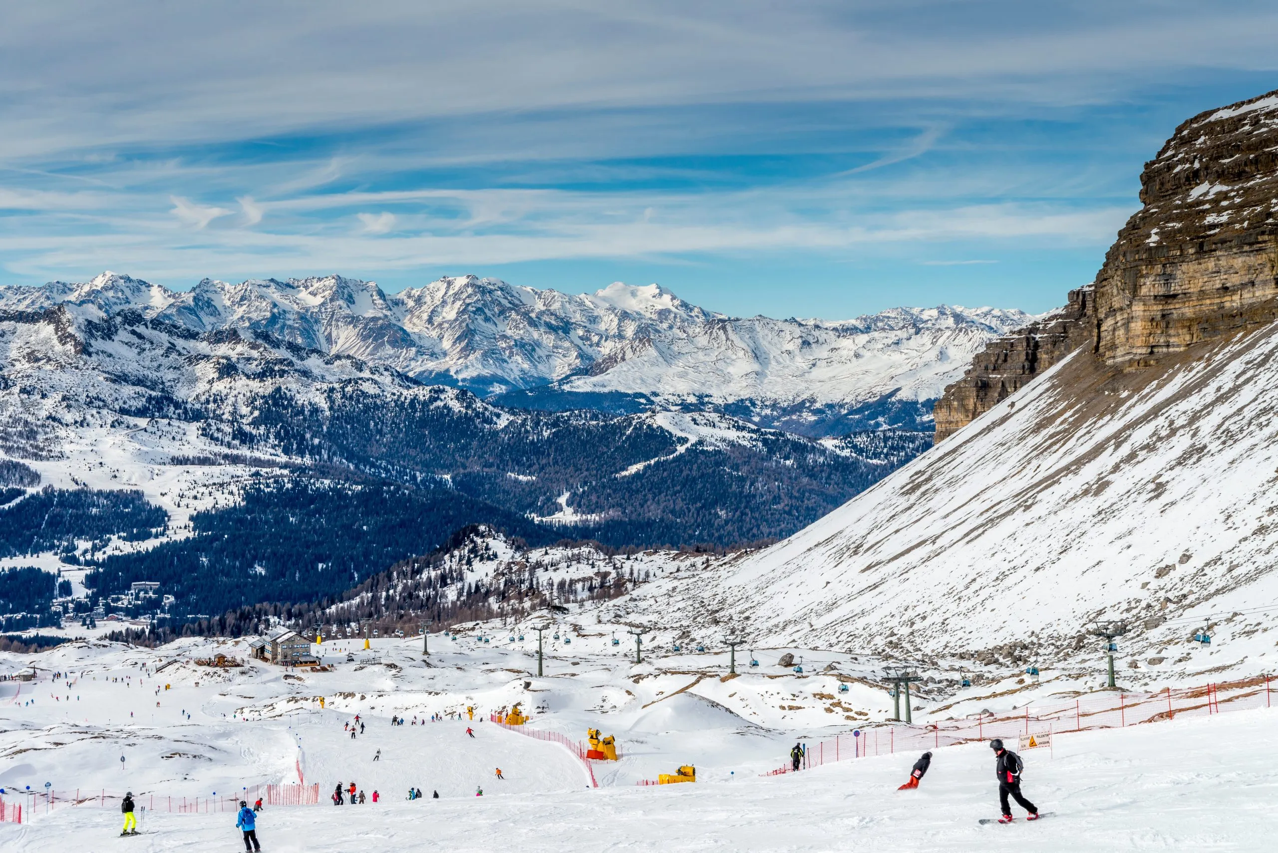 View on a sunlit ski slope and a Gondola ski lift in the Ski Resort Madonna di Campiglio